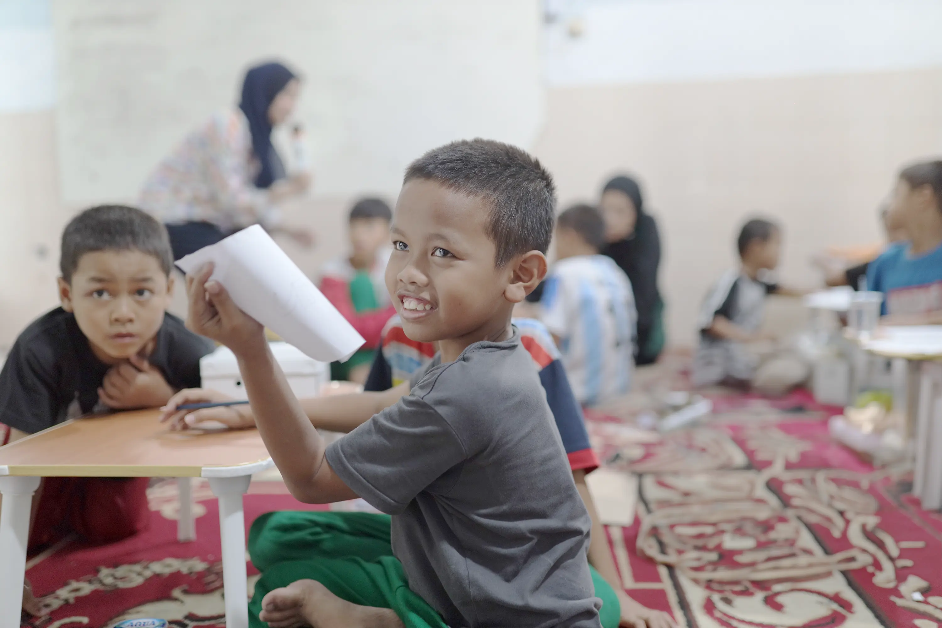 Indonesian children in classroom with books